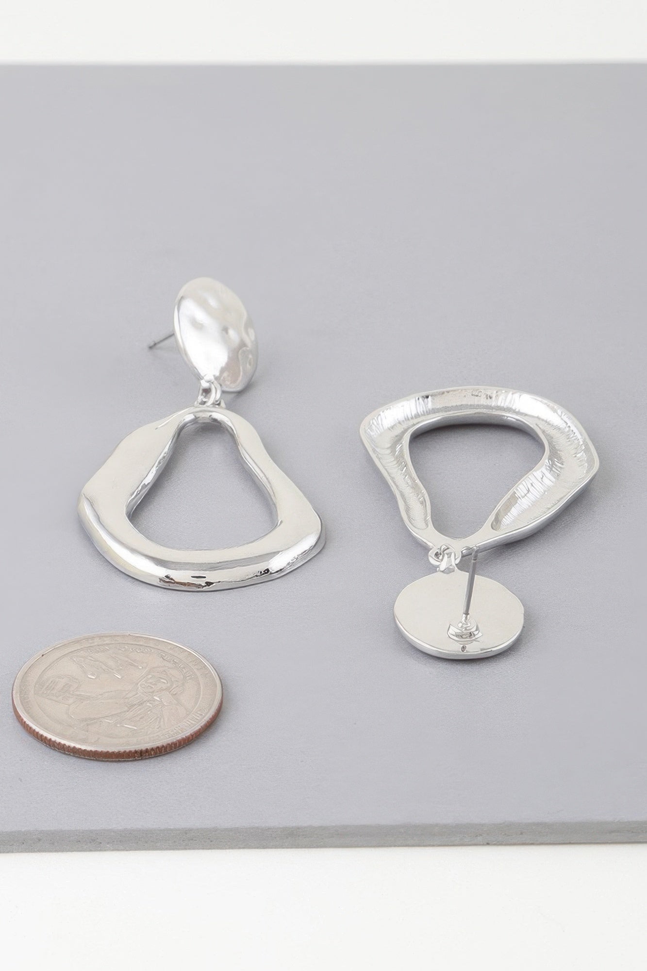 Abstract shiny teardrop earrings, silver-tone with teardrop dangle and backing disc