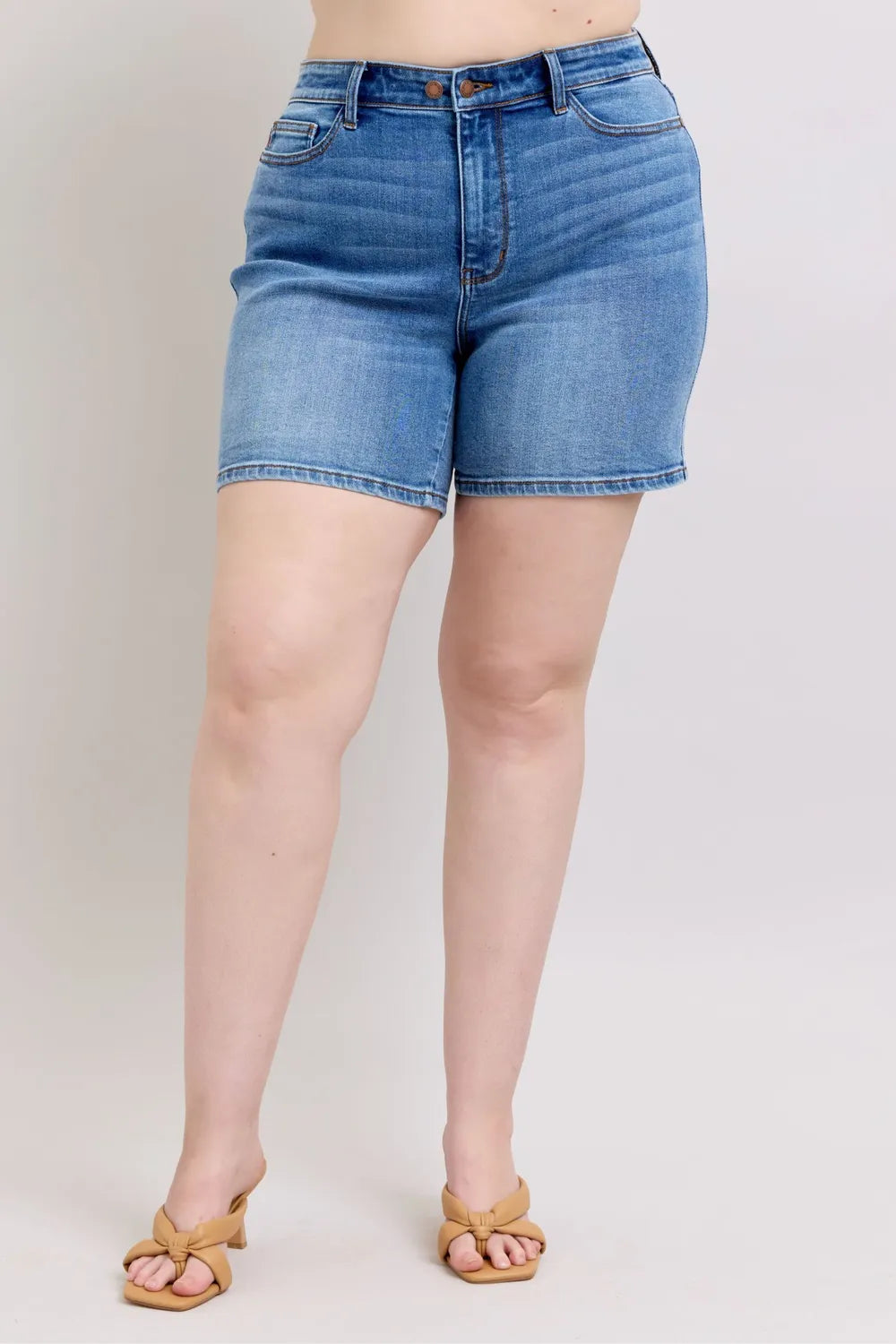 Medium wash denim shorts with 2-button fly and front pockets
