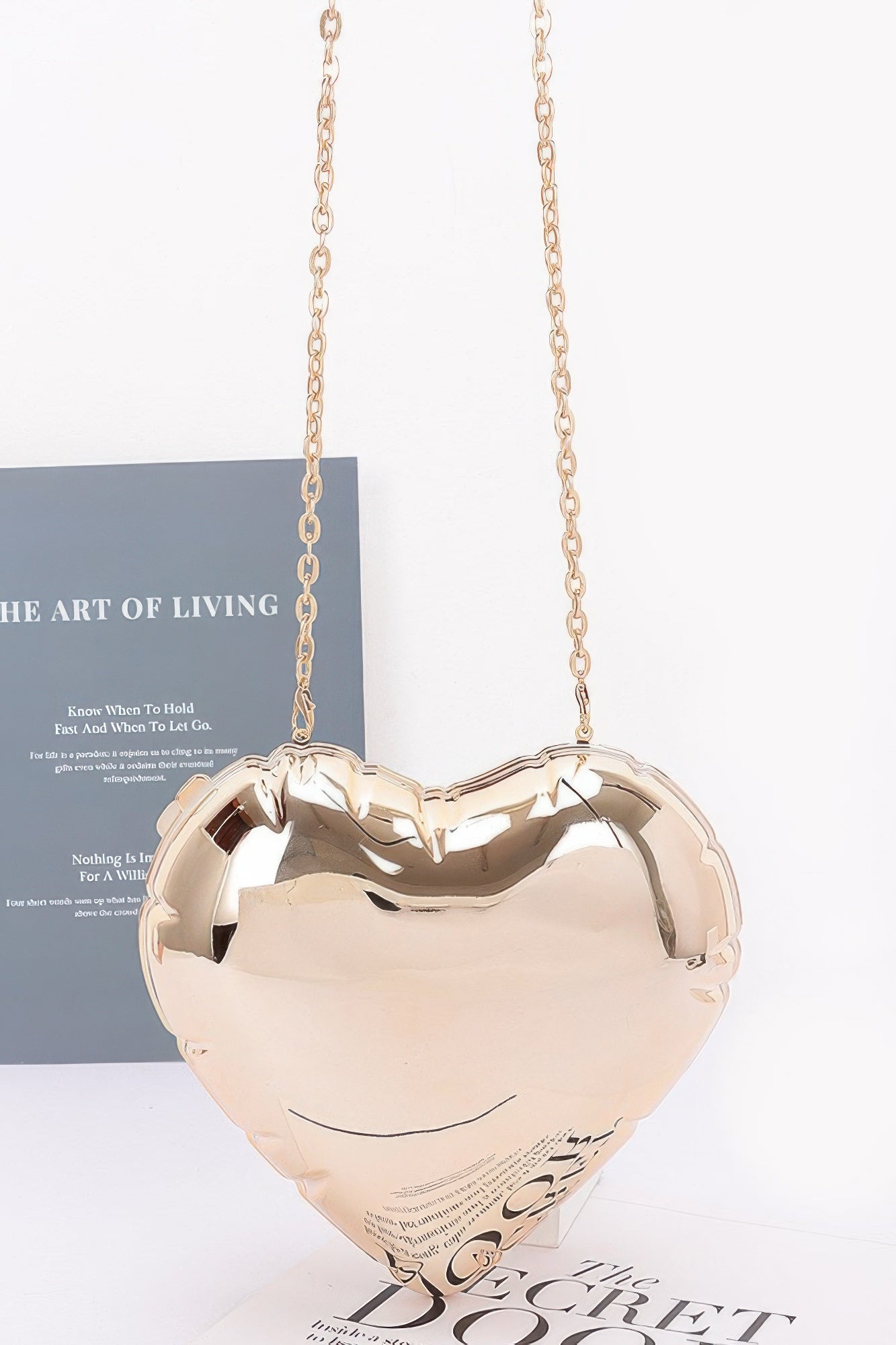 Acrylic heart crossbody bag with gold-tone chain strap, glossy heart case