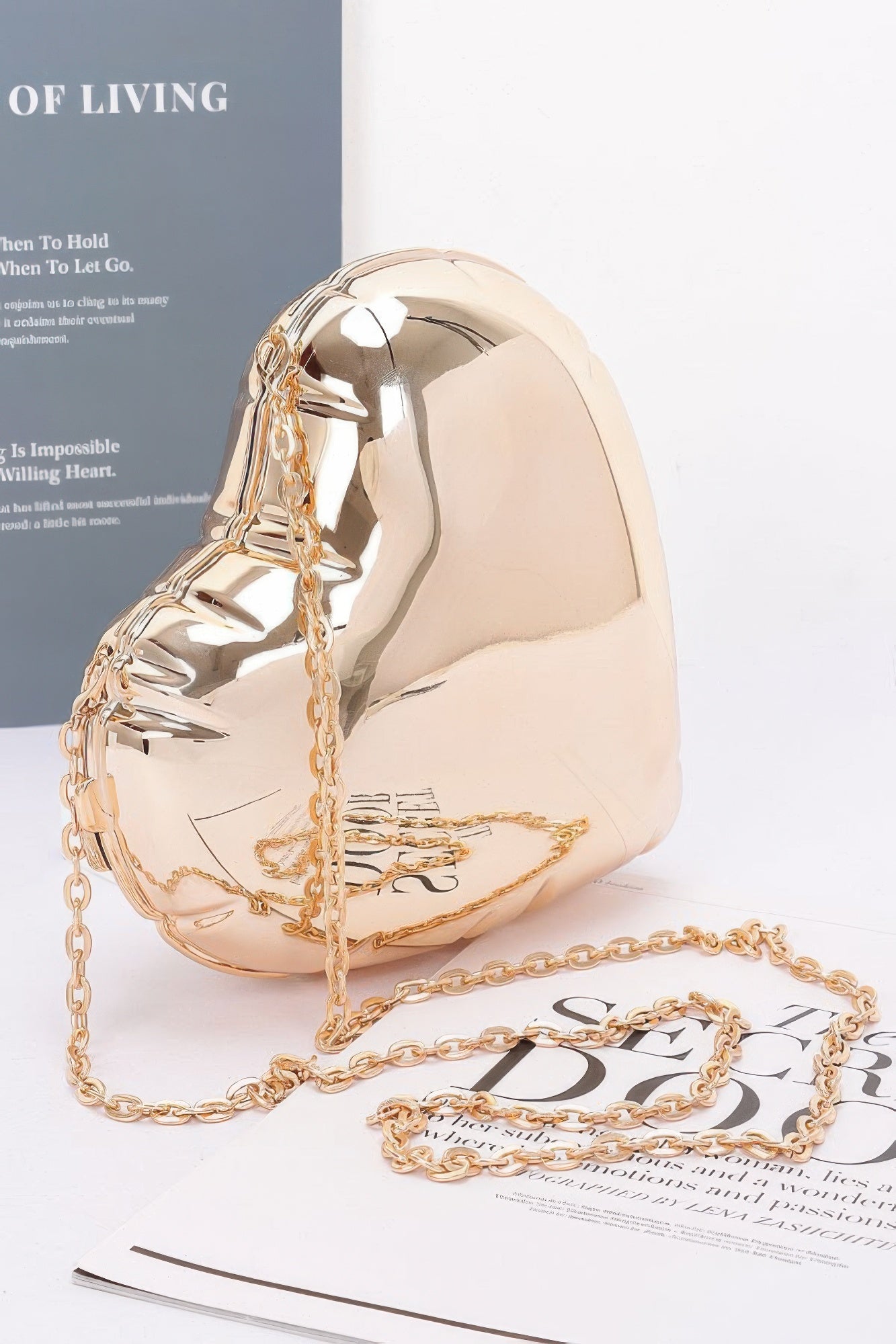 Gold-tone acrylic heart case bag with chain strap and heart-shaped body
