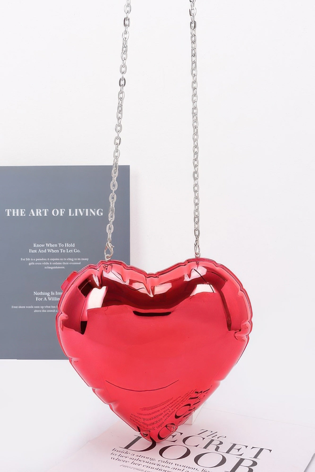 Red acrylic heart crossbody case bag with silver-tone chain strap