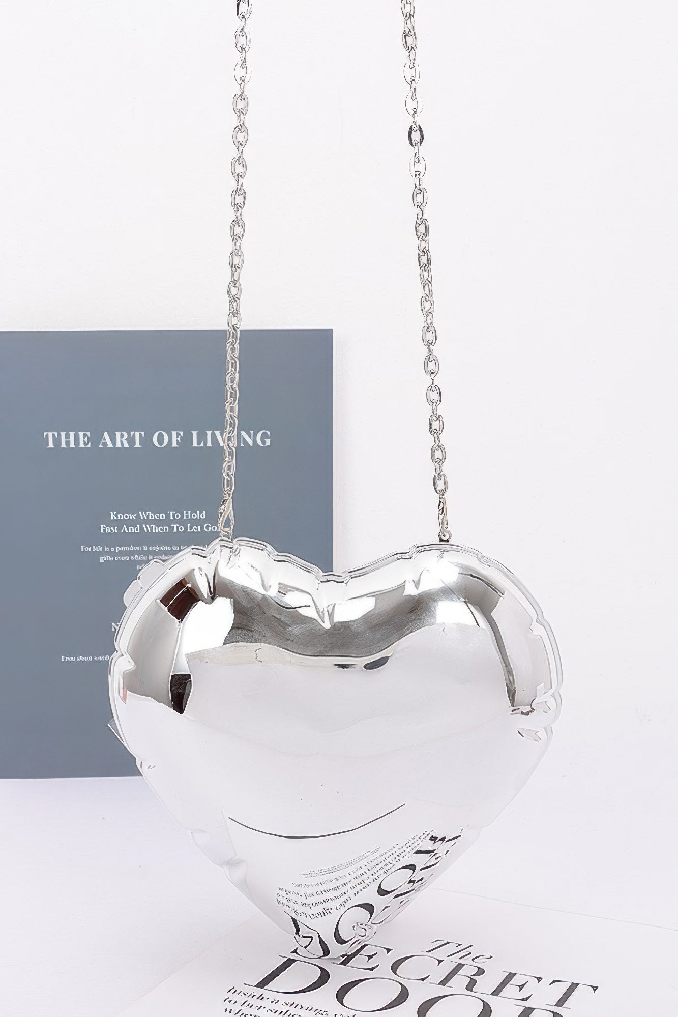 Silver acrylic heart crossbody case bag with chain strap, glossy heart shape