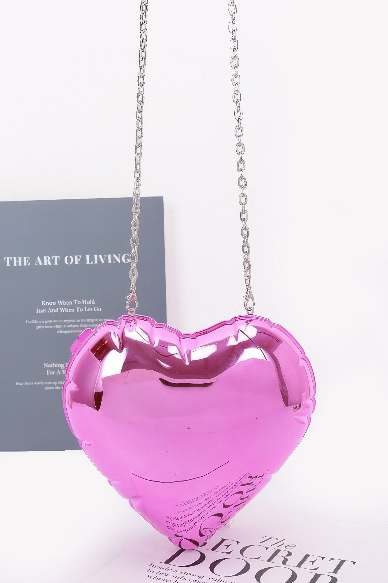 Pink acrylic heart crossbody case bag with silver-tone chain strap, glossy finish