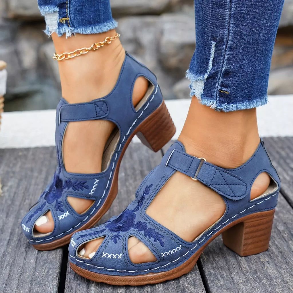 Blue cutout block heel sandals with buckle ankle strap and stitched floral design