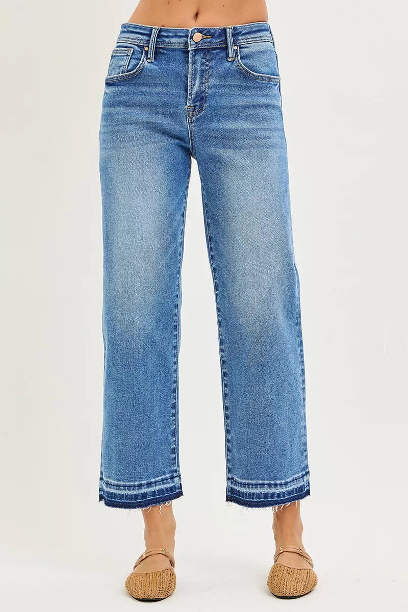 Medium-wash cropped boyfriend jeans with relaxed fit; cuffed hems and belt loops