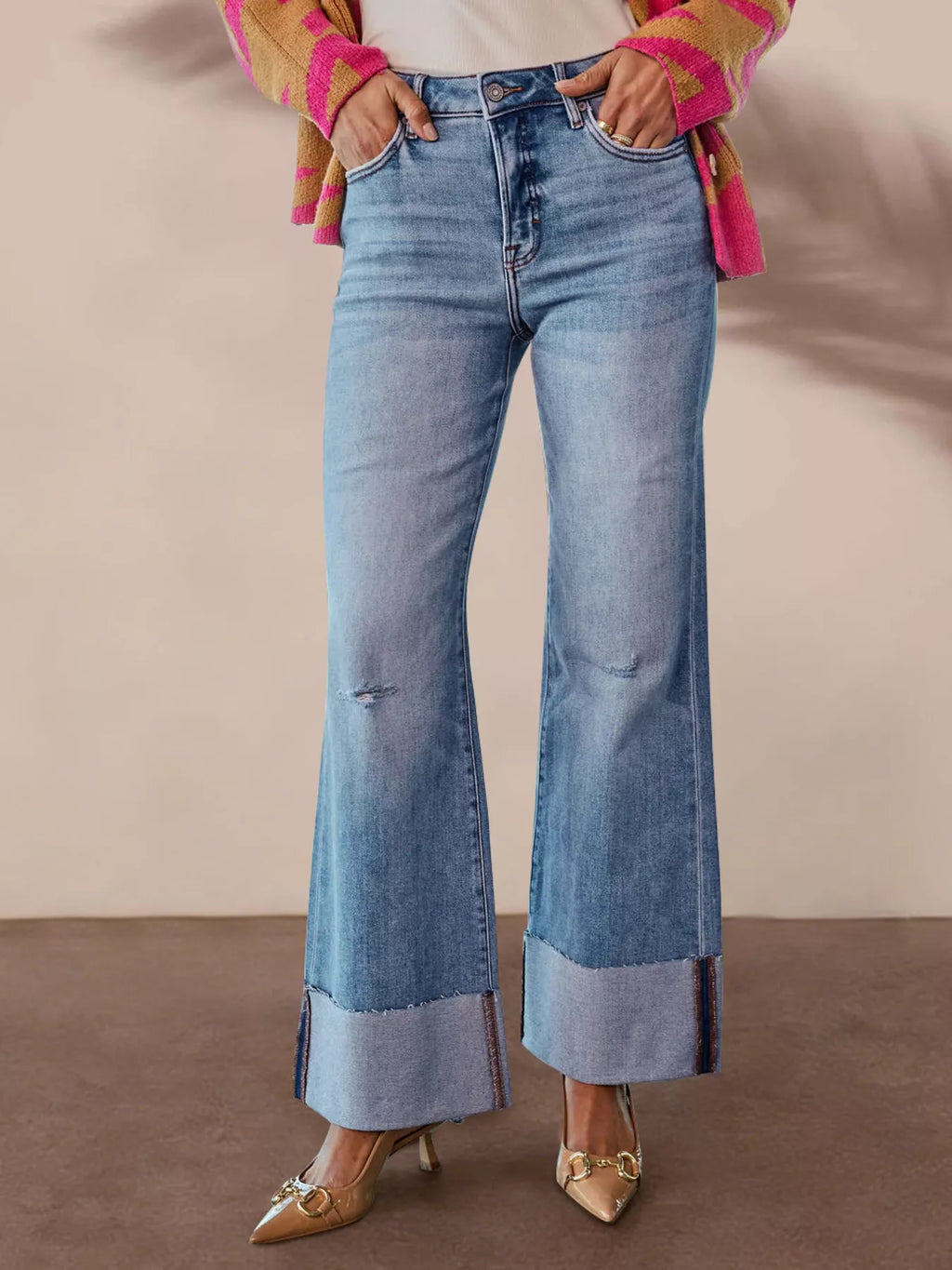 Blue distressed high-waisted wide-cuff flare jeans with a button fly and front pockets