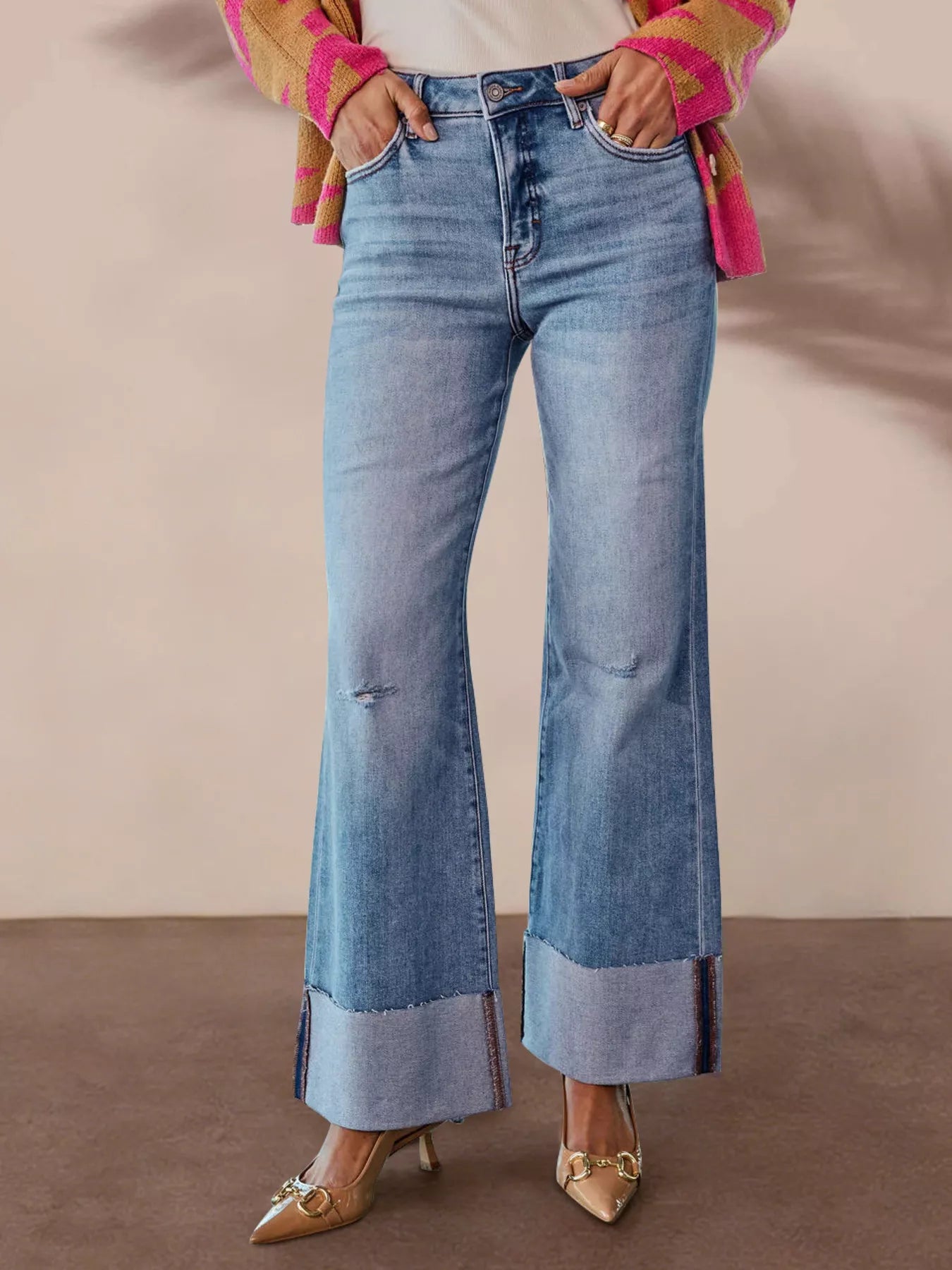 Blue distressed high-waisted wide-cuff flare jeans with a button fly and front pockets