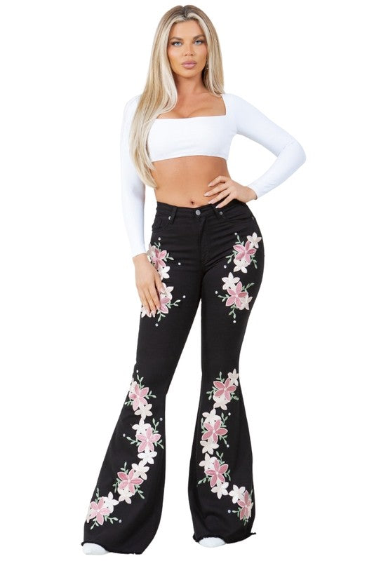 Black flare jeans with pink floral embroidery and button-front waistband