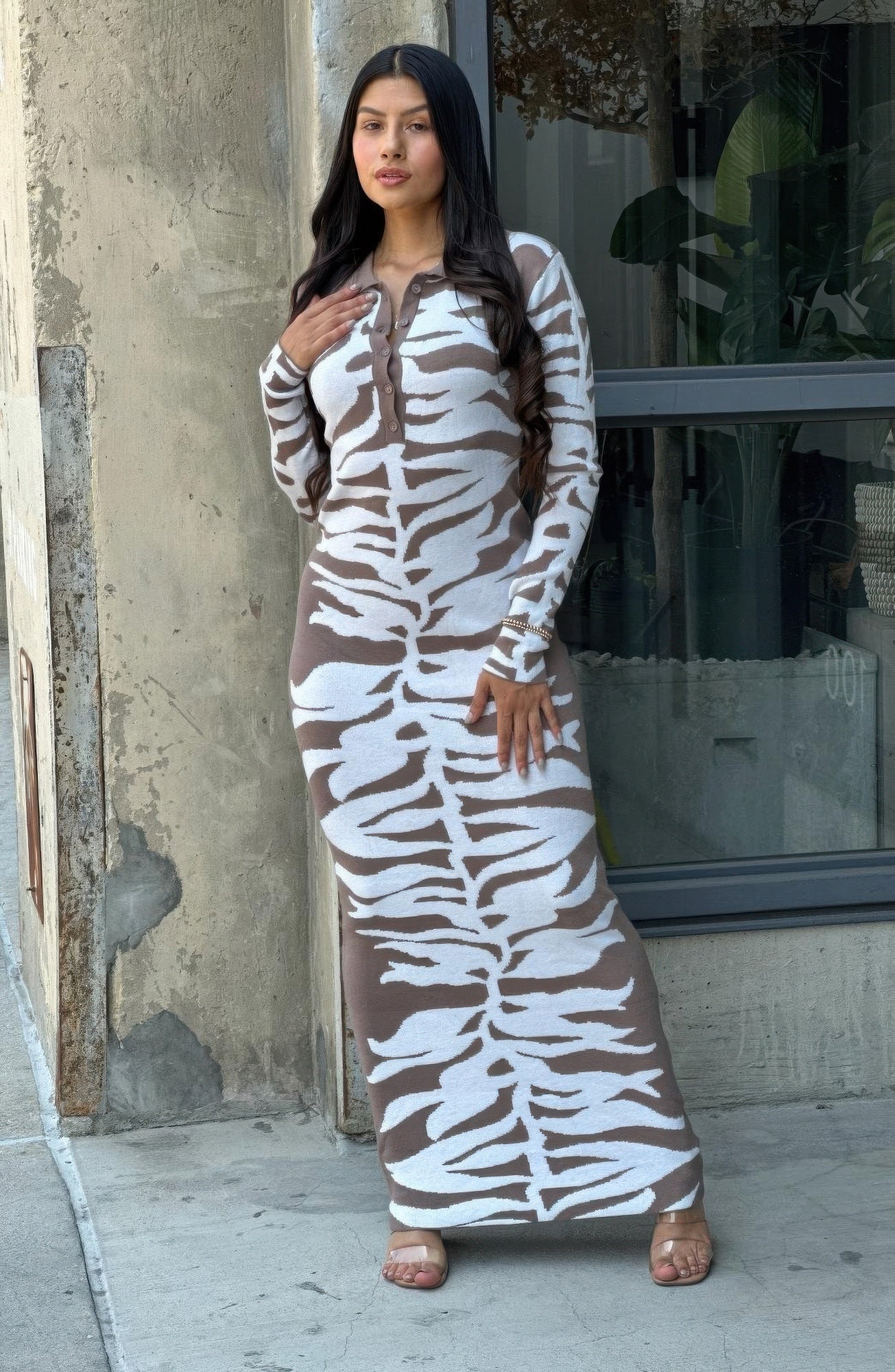 Brown-and-white zebra print bodycon sweater dress with long sleeves and chest button placket