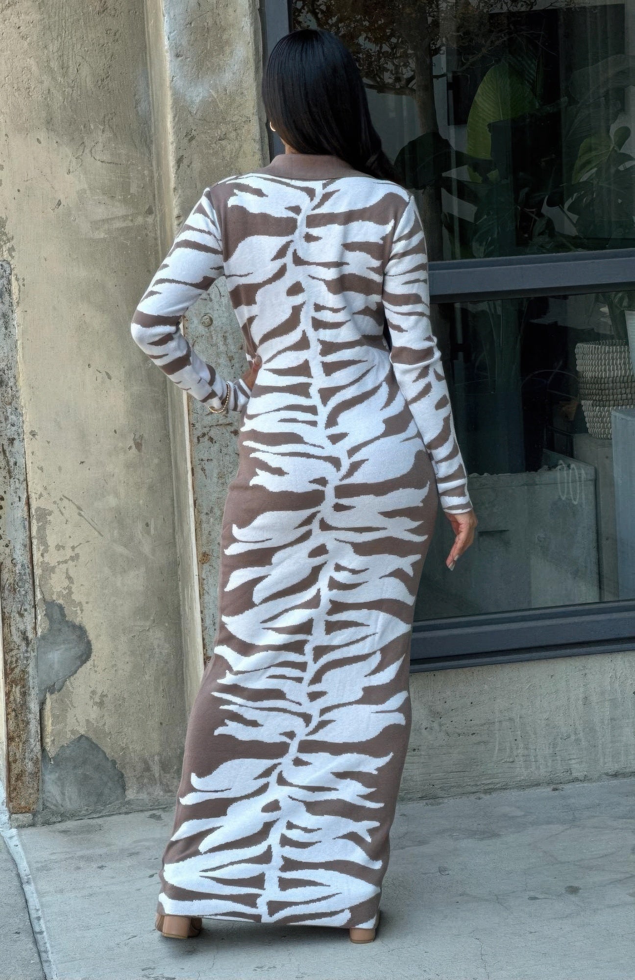 Back of animal print sweater dress, fitted bodycon maxi with long sleeves, zebra print pattern