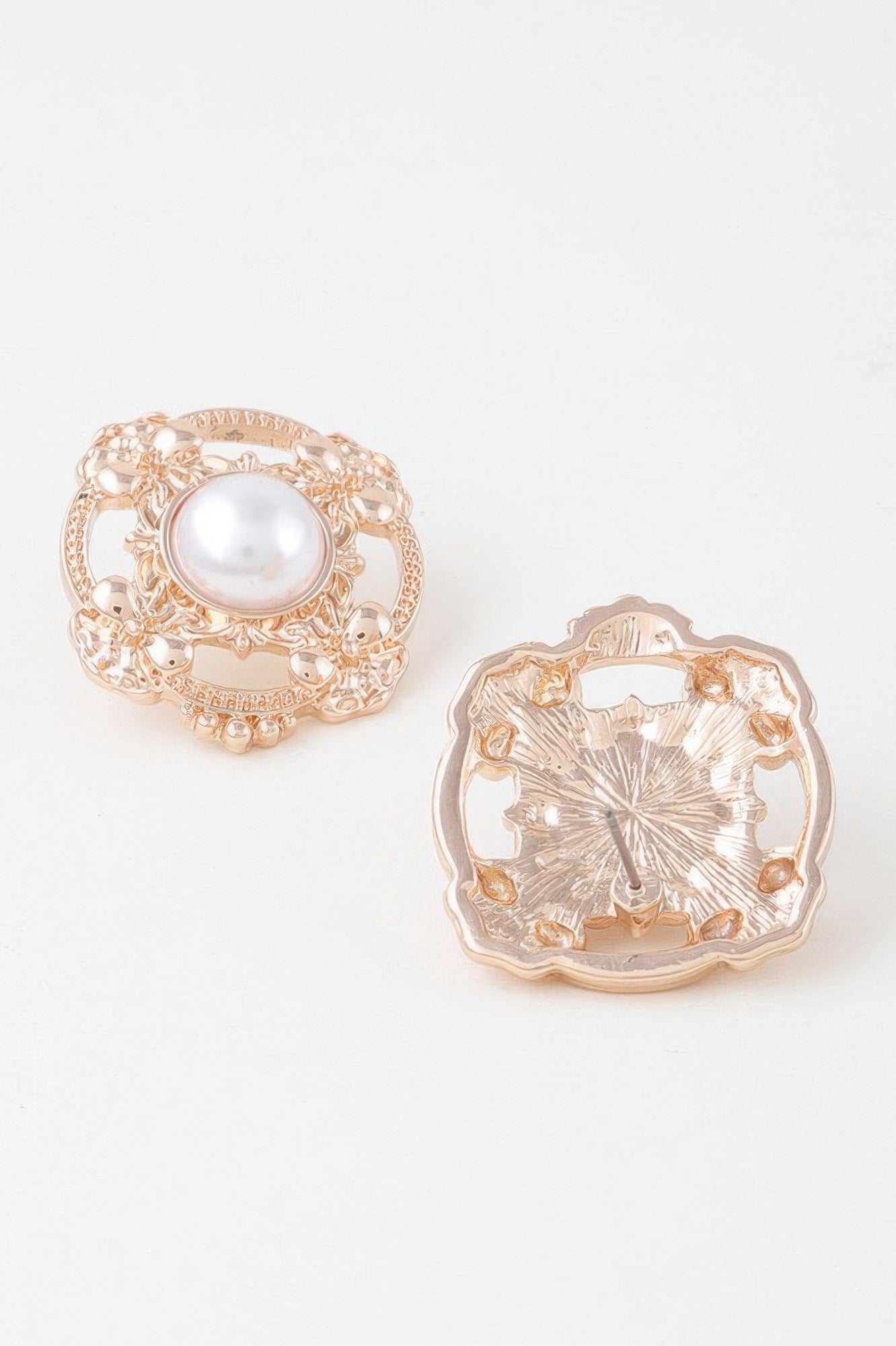 Antique ribbon pearl stud earring, rose-gold tone back plate with central pearl