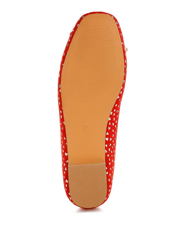 Red suede ballerina flats underside insole view with foil speckle print around edges