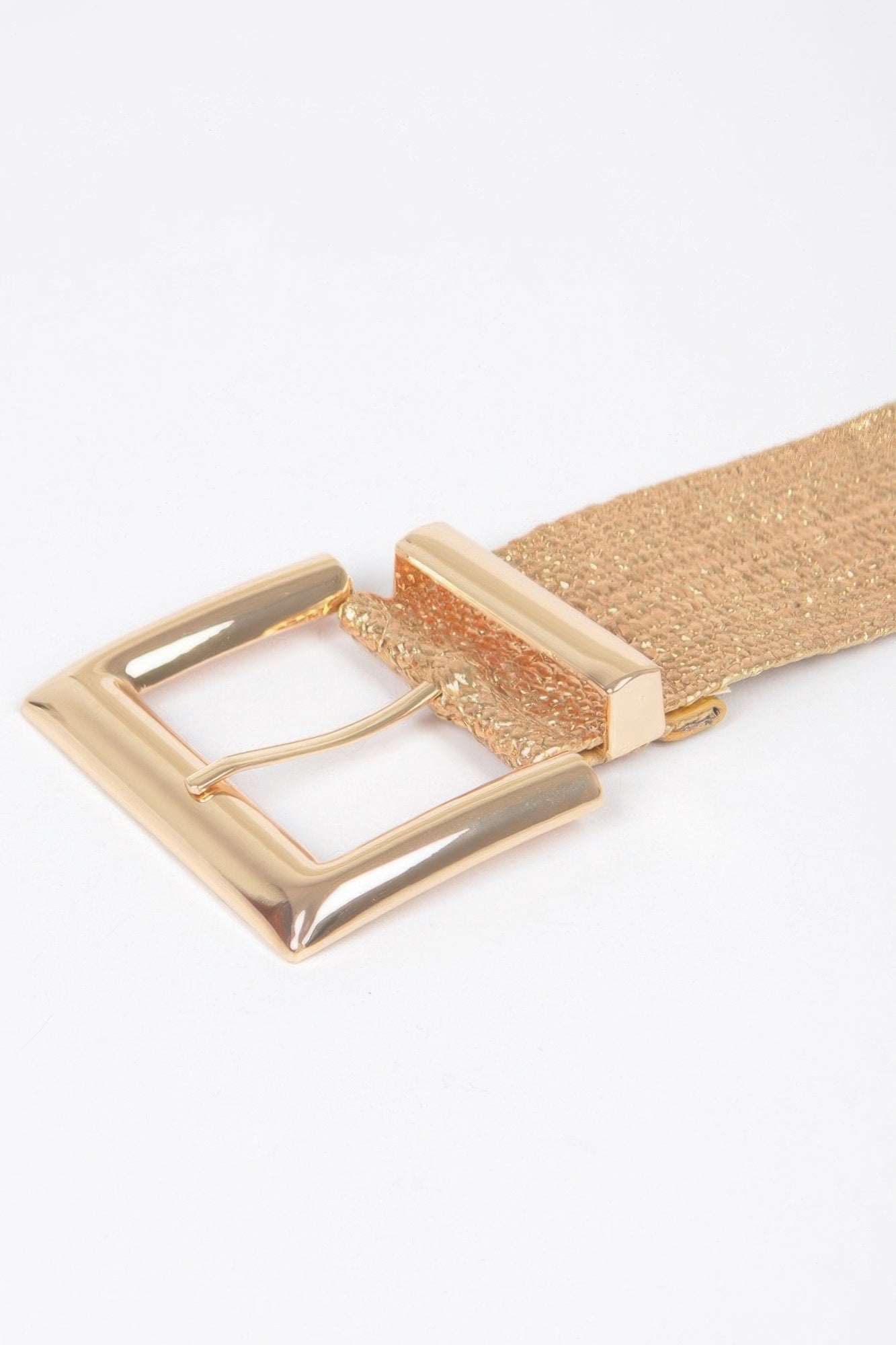 Close-up: gold rectangular buckle on wide shimmer belt strap