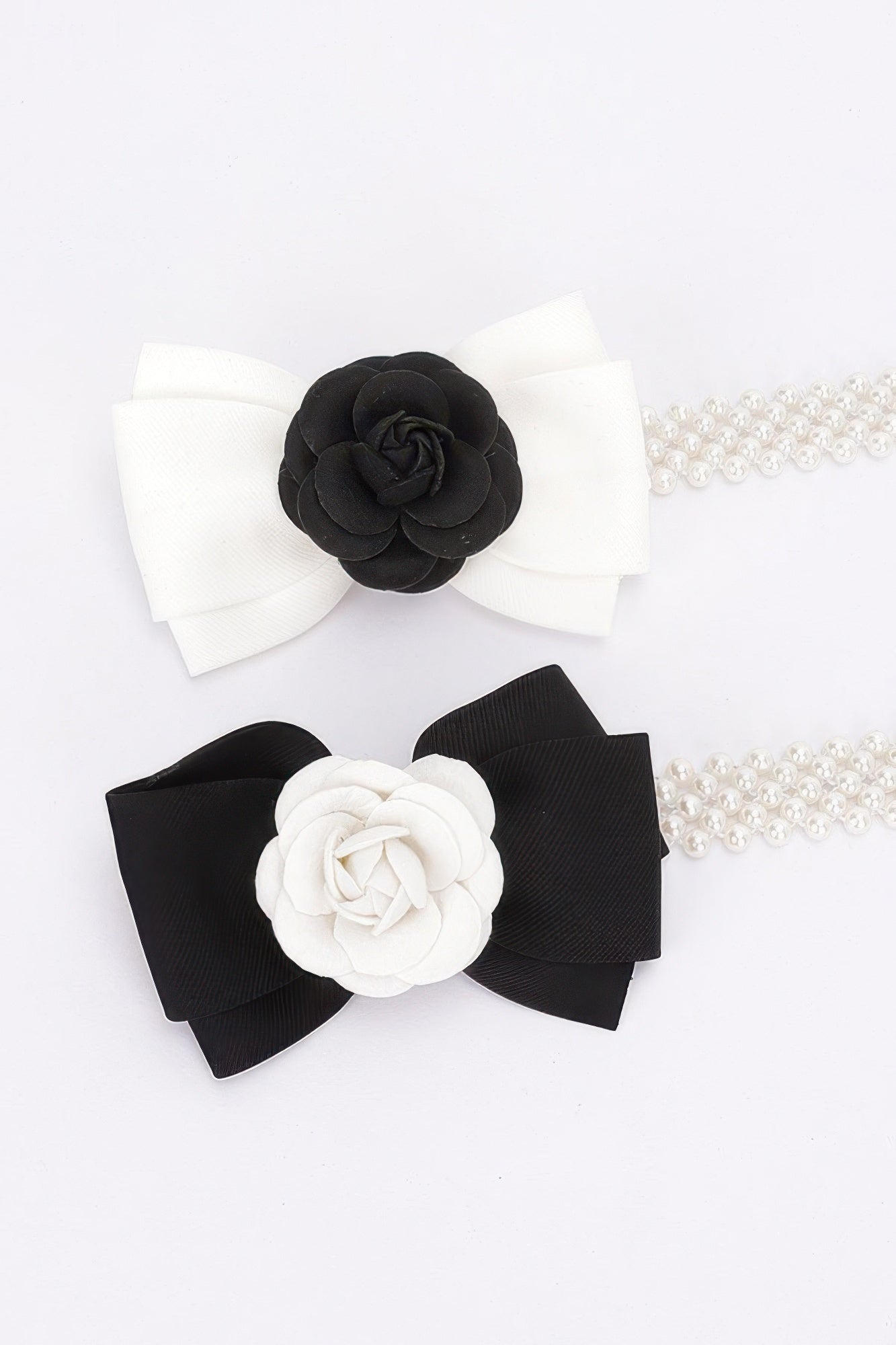 Two flower ribbon faux pearl stretch belts: white and black bow styles