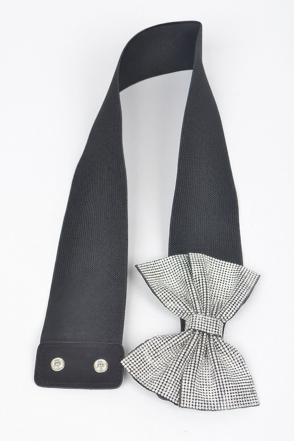 Black elastic belt with bow tie made of clear rhinestones, hanging view