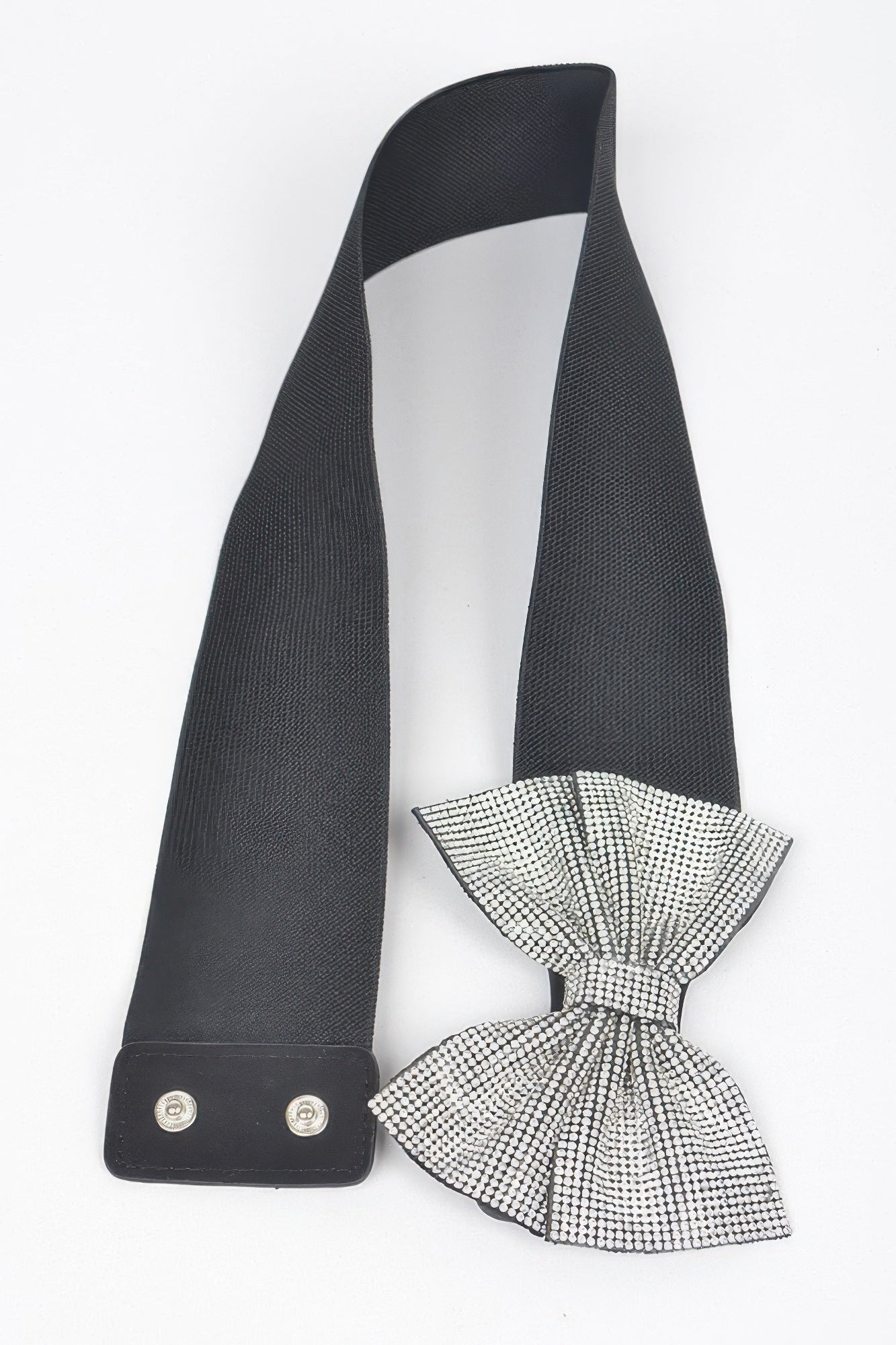 Black elastic belt with bow tie made of clear rhinestones, hanging view