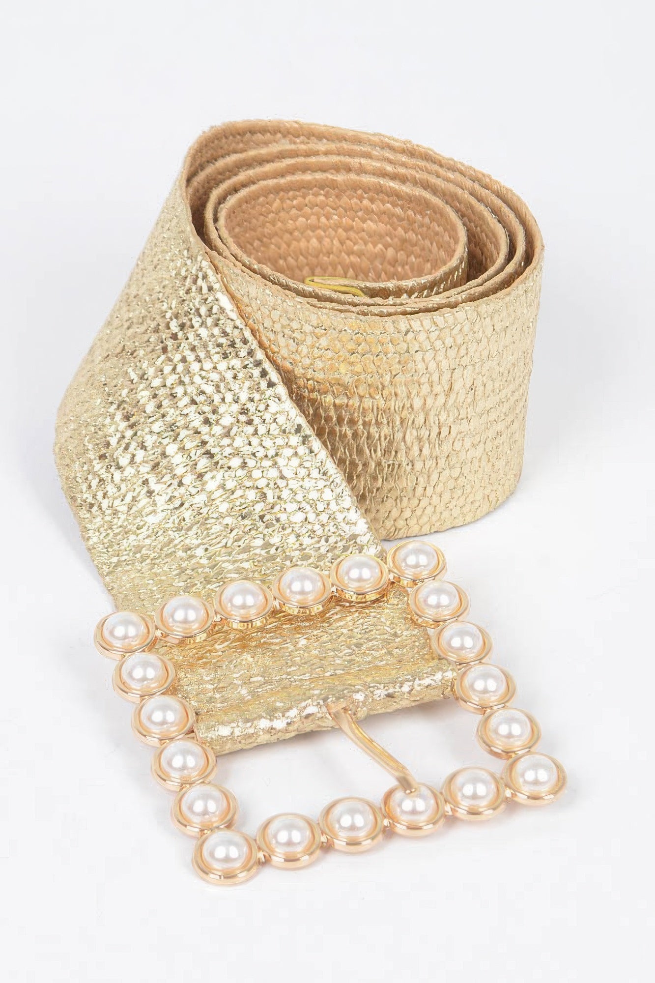 Gold wide belt close-up with textured fabric and pearl buckle border