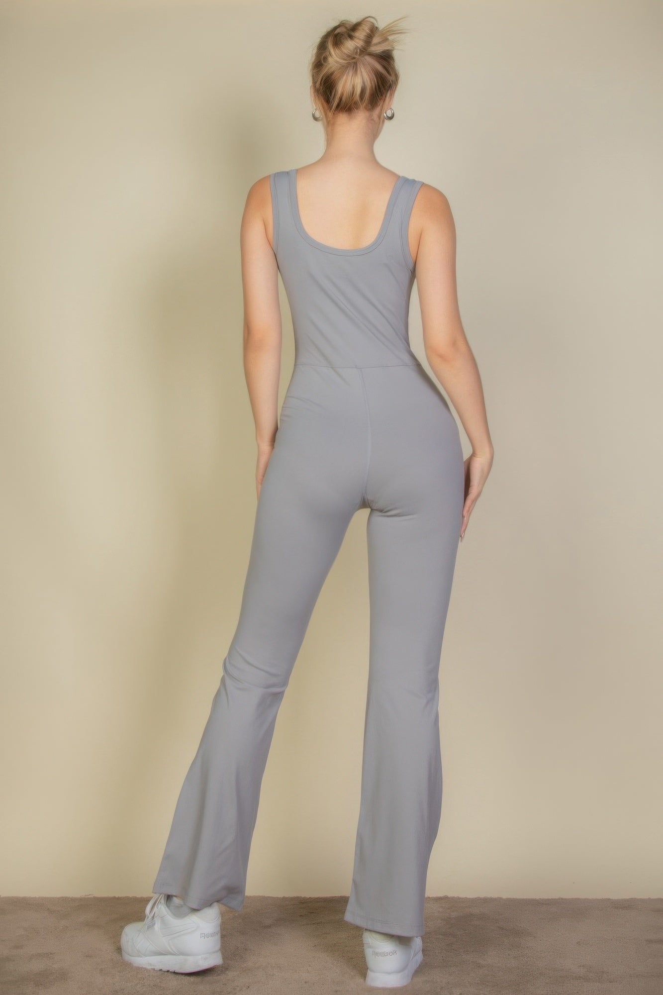 Back view of cement gray flare-leg sports jumpsuit, sleeveless scoop back
