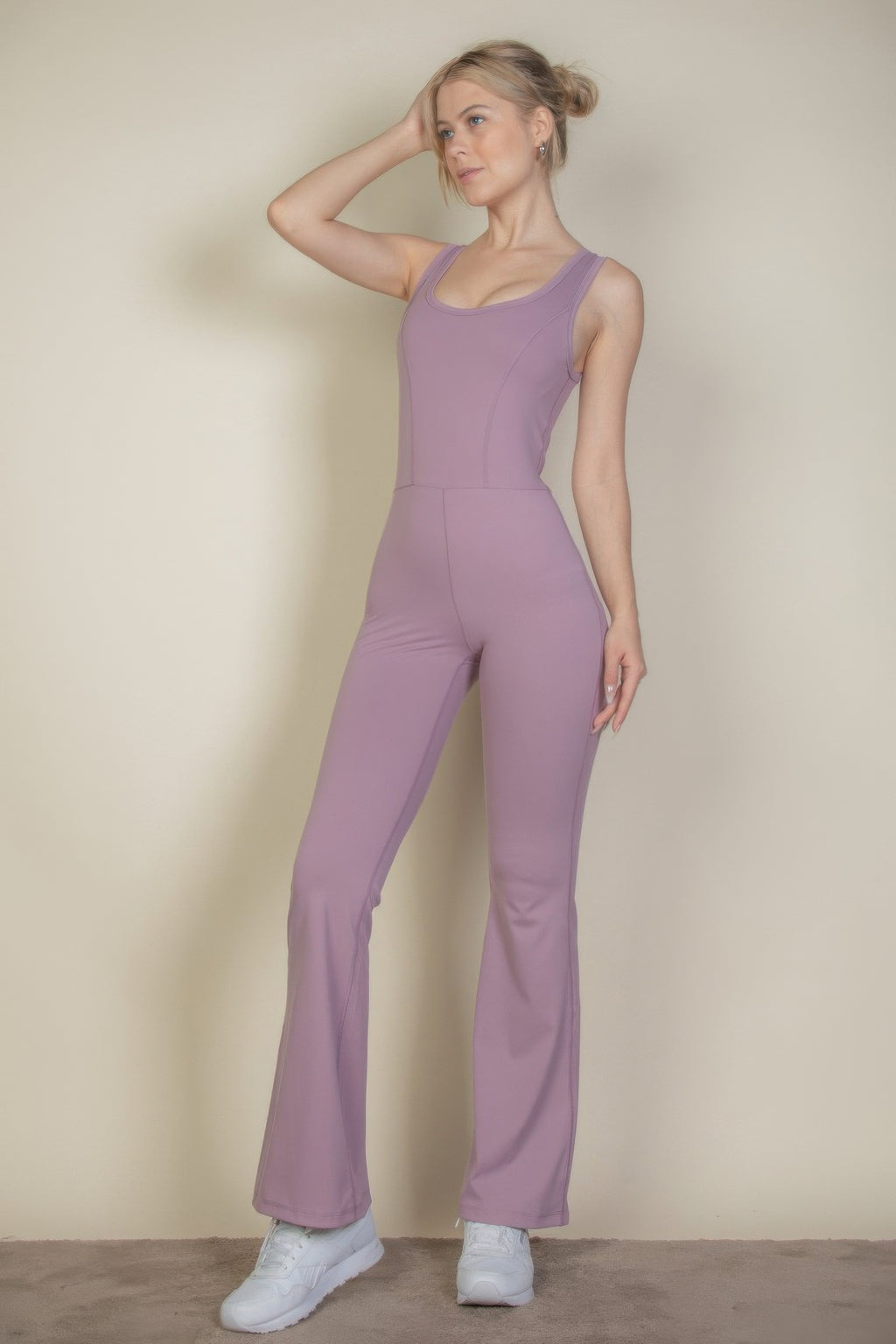 Smoky pink sports jumpsuit with wide bell bottoms and front seam detailing