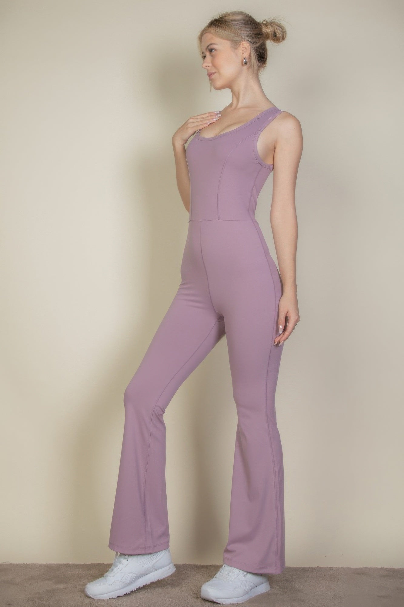 Smoky pink flare-leg jumpsuit in side view with wide-leg silhouette