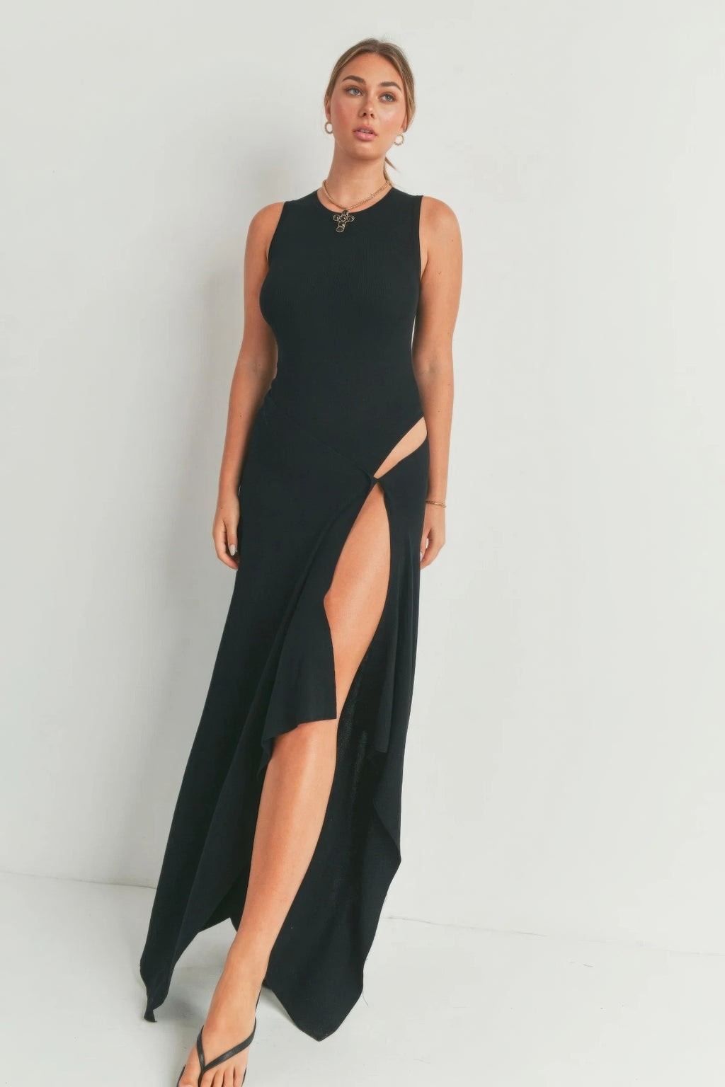 Black sleeveless long dress with front thigh slit and flowing maxi hem
