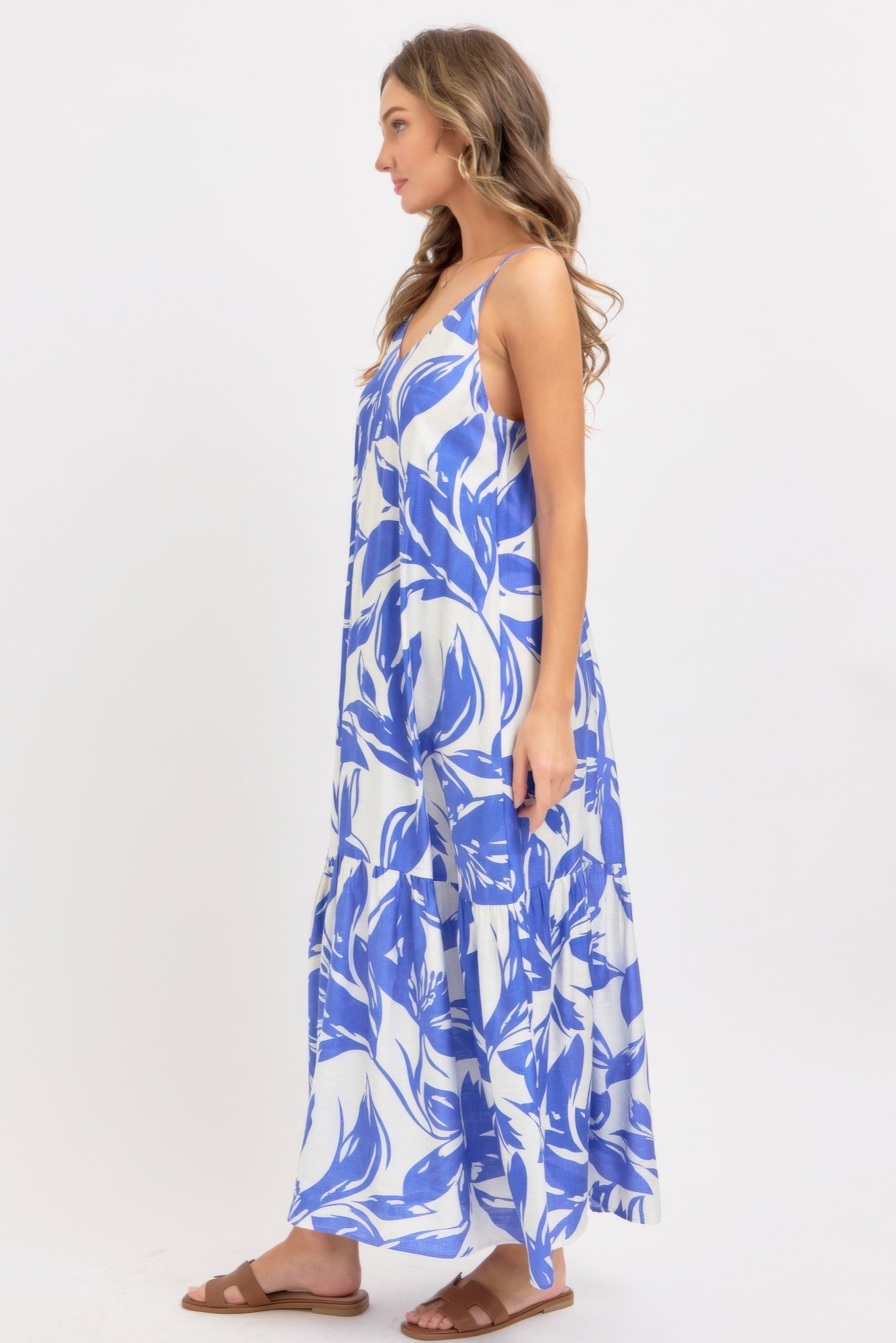 Side view of blue floral maxi sundress with tiered skirt and thin straps