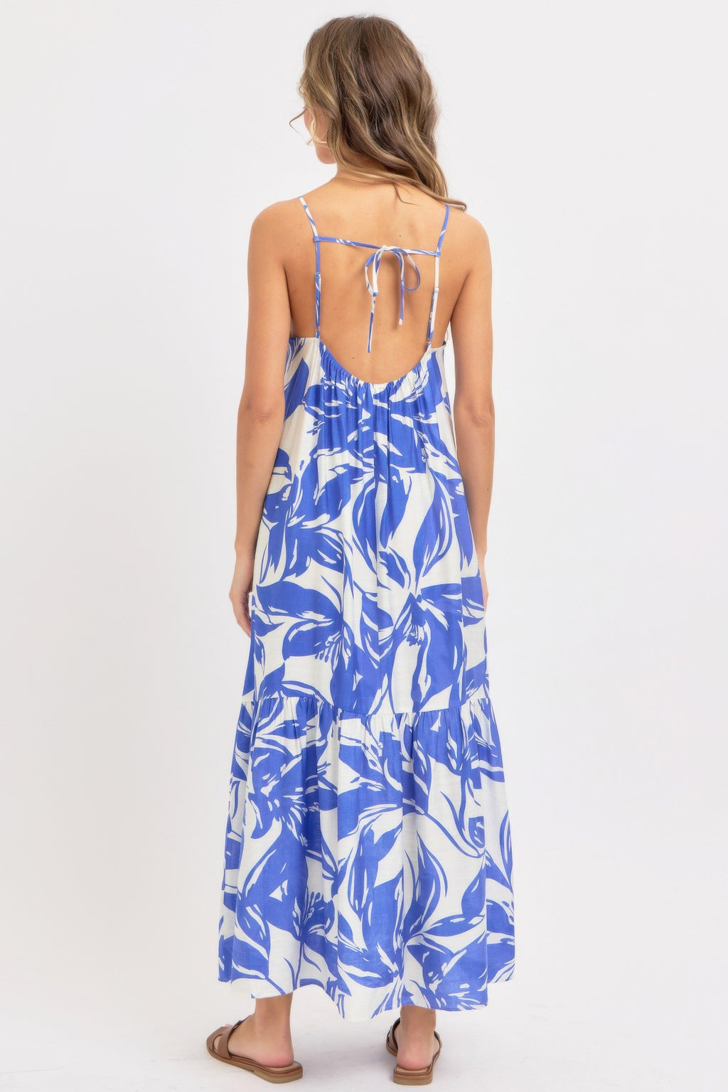 Rear view of blue floral maxi sundress with open back and tie-strap closure