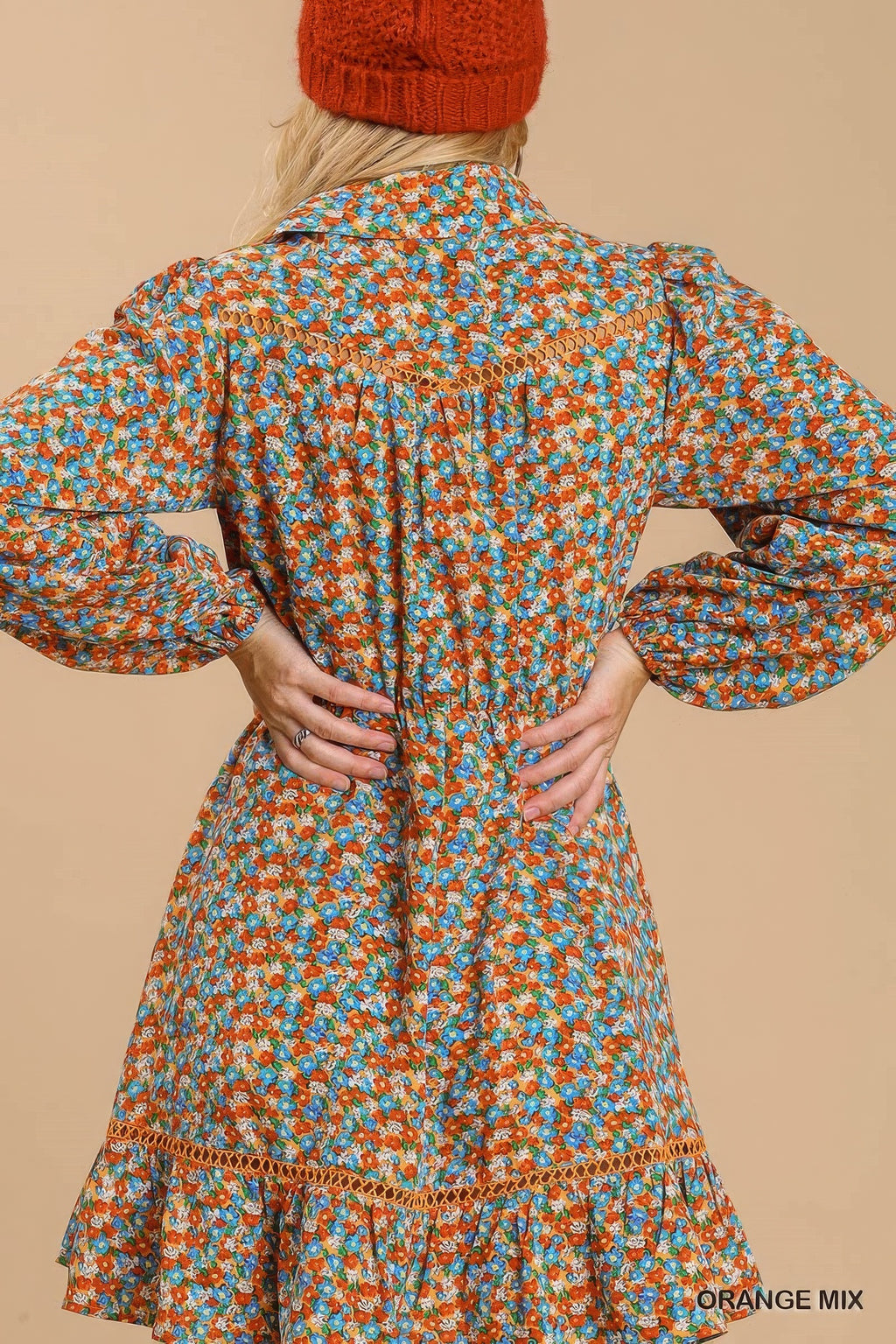 Back view of orange floral button-down dress with gathered yoke and tiered skirt