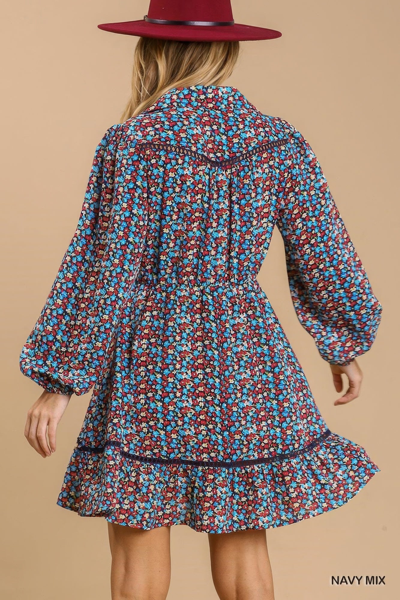 Back view of navy floral collared button-down mini dress with tiered ruffle hem