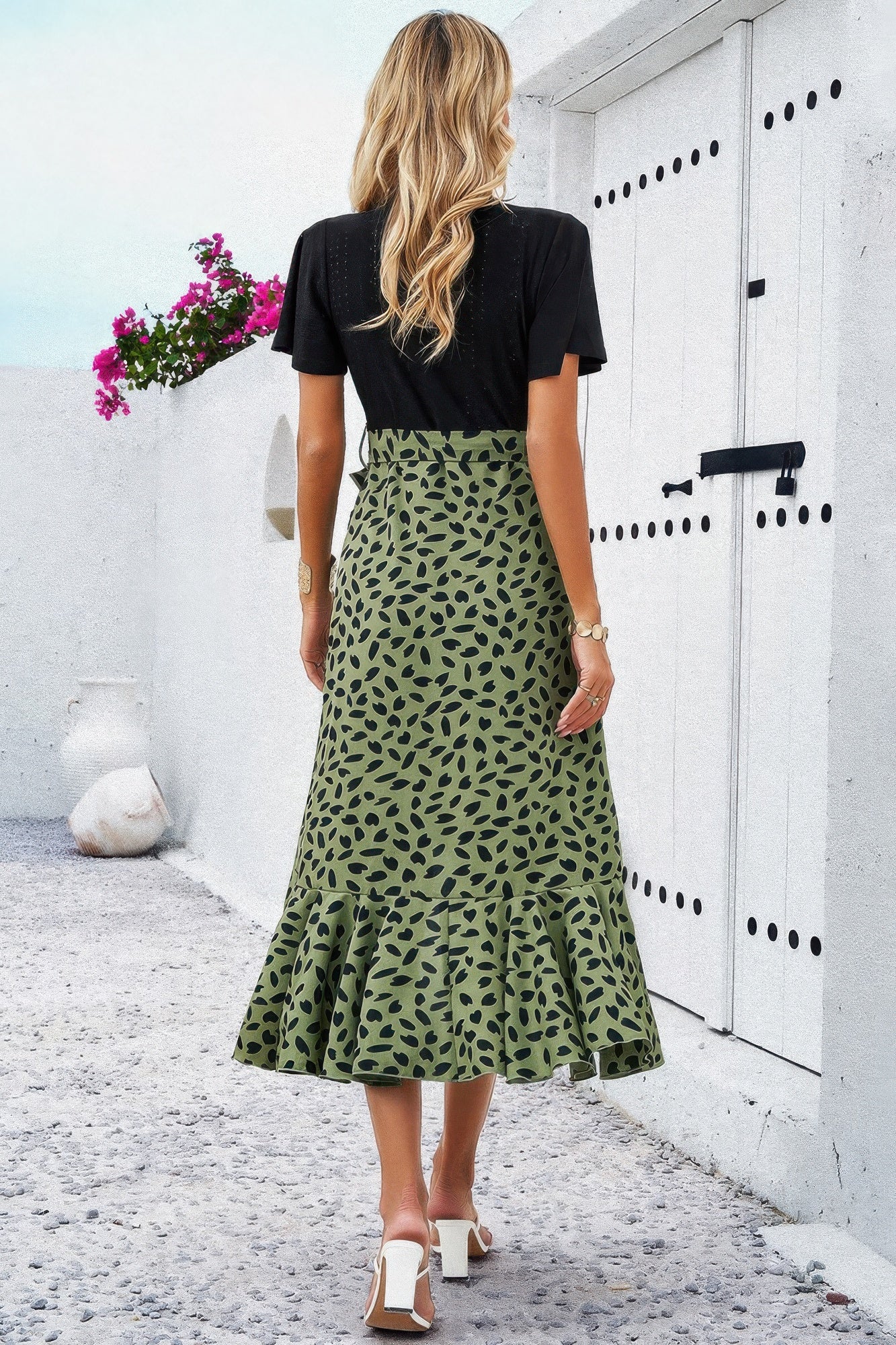 Back view: black short-sleeve V-neck dress with green leopard-print midi skirt