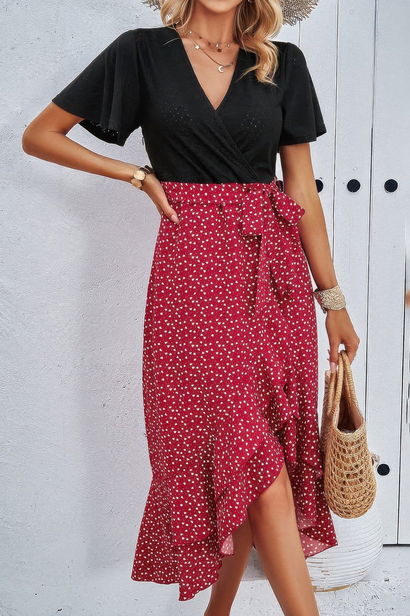 Wine red dot-print skirt with black V-neck wrap bodice and tied waist detail
