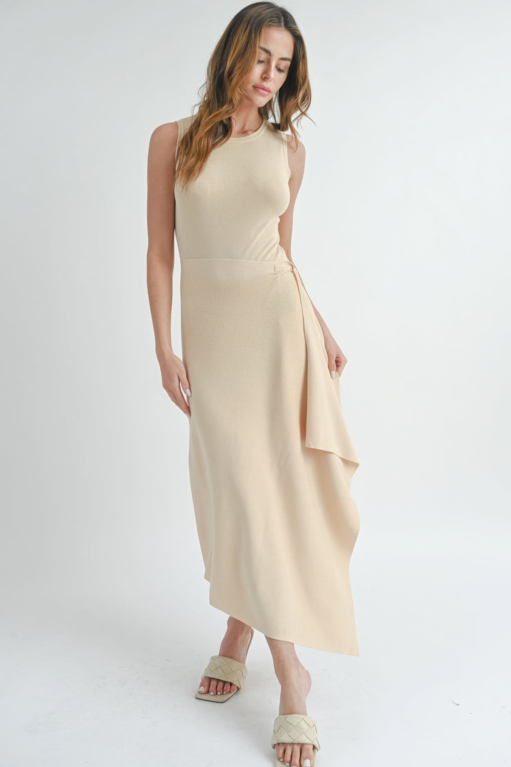 Natural beige sleeveless maxi dress with side slit and asymmetric draped hem