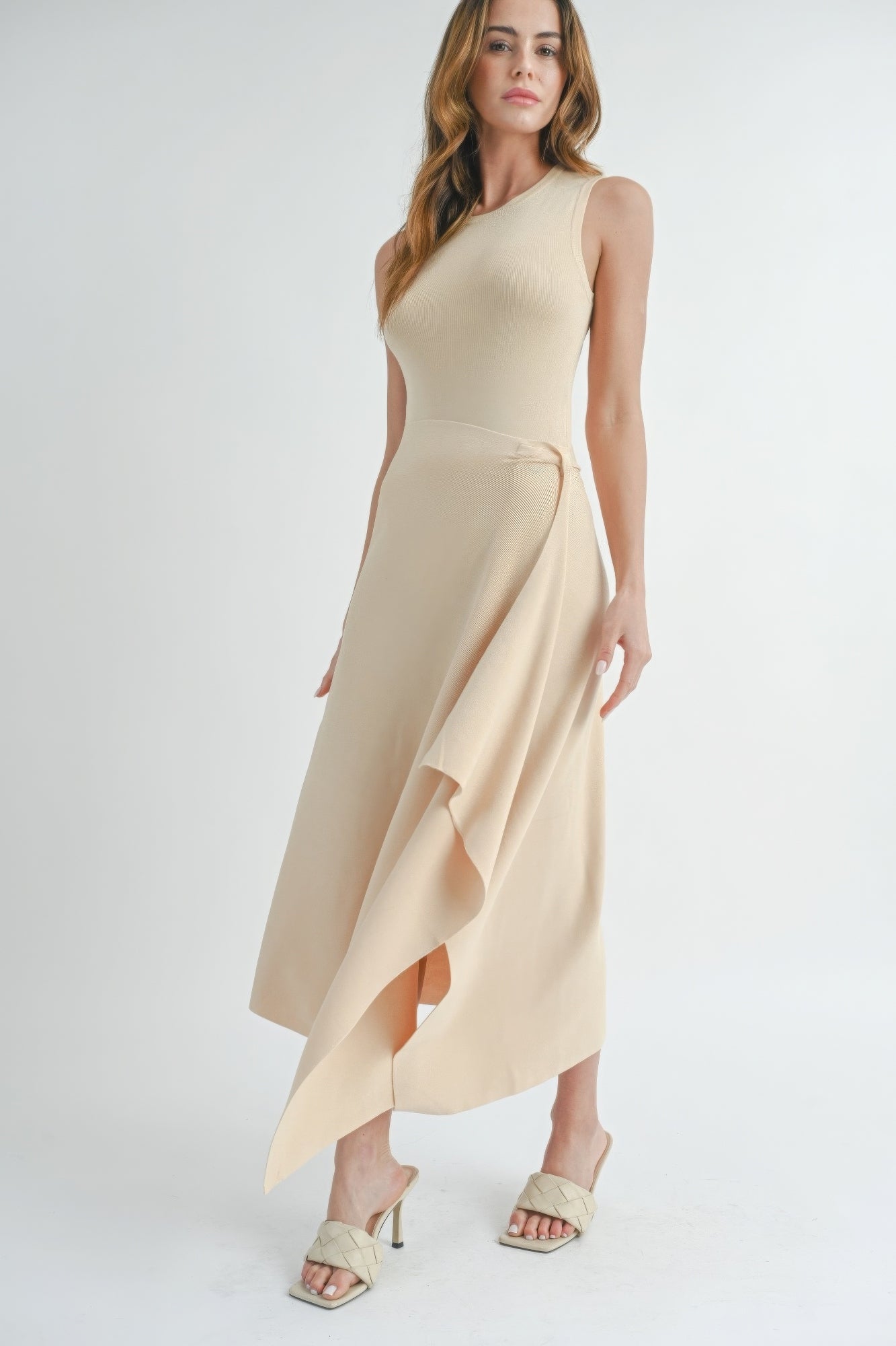 Natural beige sleeveless maxi dress with side slit and angled asymmetric hem