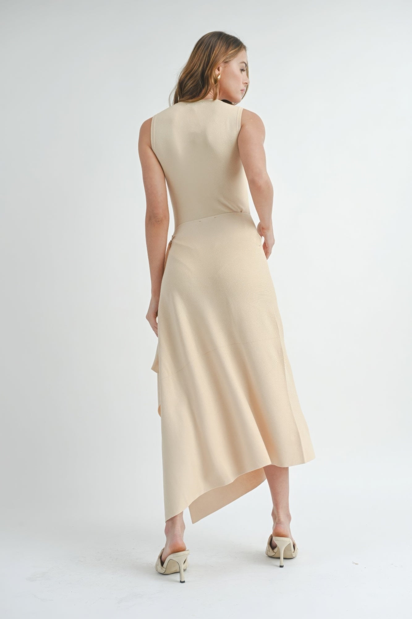 Natural beige sleeveless maxi dress from back view with asymmetric hem