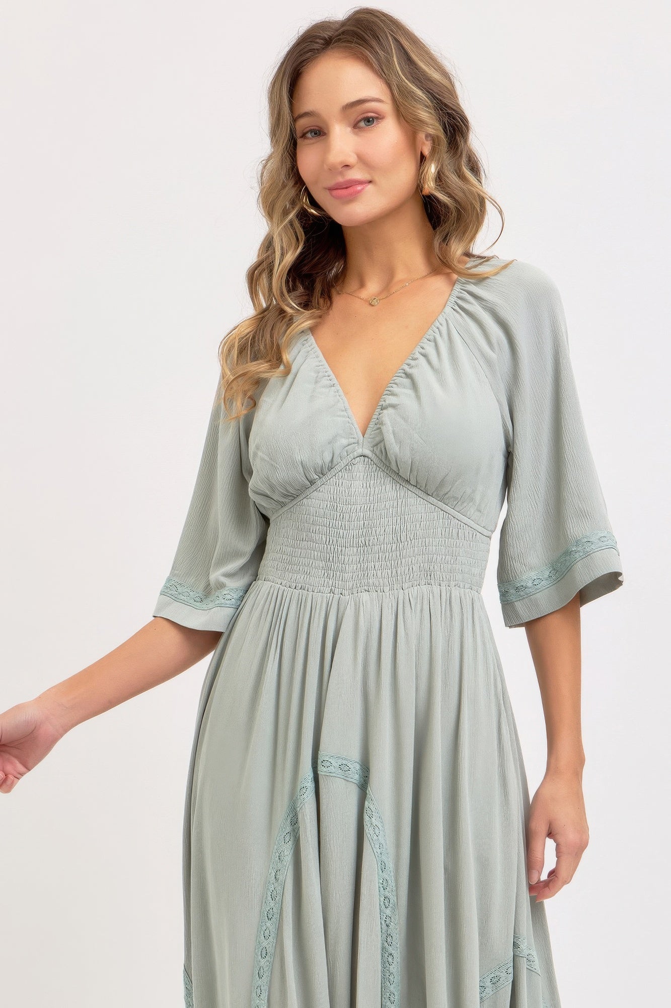 Dusty sage maxi dress close-up: V-neck bodice with smocked waist detail