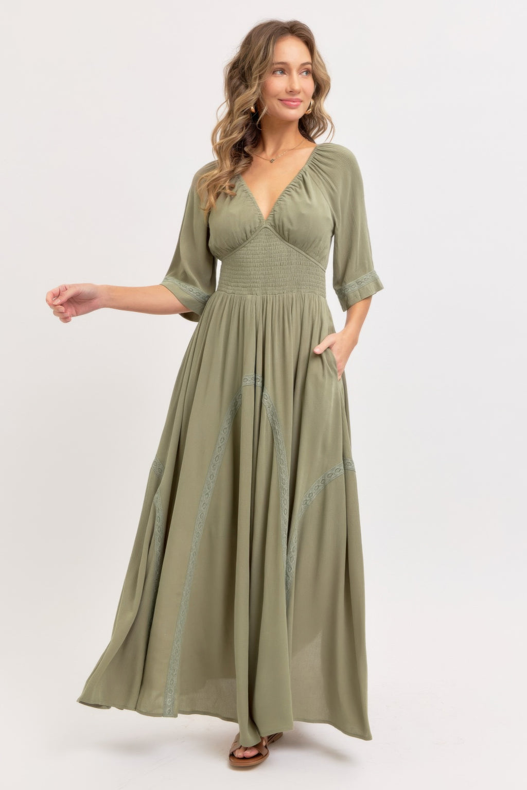 Dusty sage maxi dress with V-neck, flowing tiers, smocked waist, embroidered hem