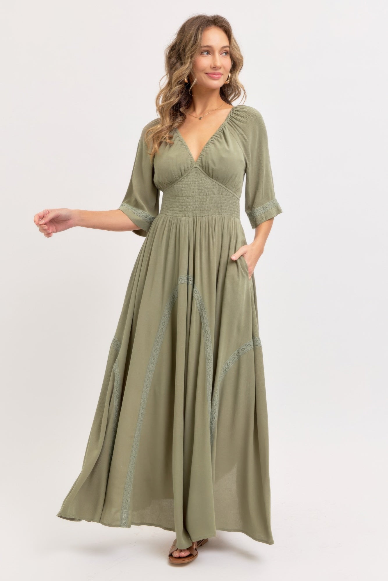 Dusty sage maxi dress with V-neck, flowing tiers, smocked waist, embroidered hem