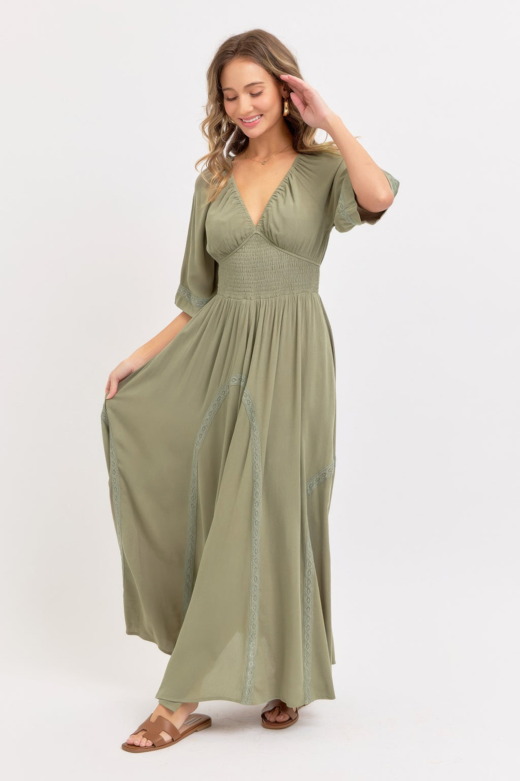 Dusty sage flowy maxi dress side view with V-neck and embroidered hem panel