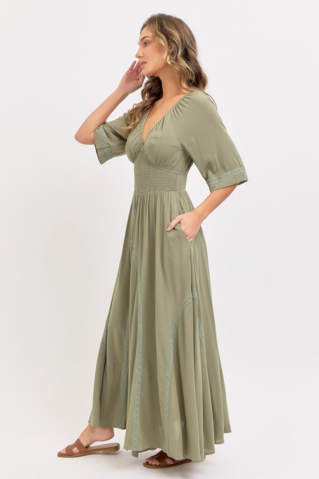 Dusty sage maxi dress with V-neck, gathered waist, and tiered full skirt