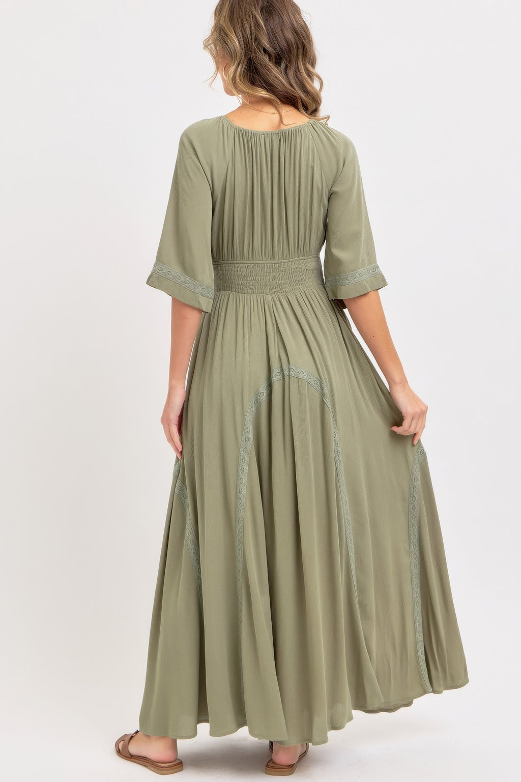 Dusty sage maxi dress, back view with smocked waist and embroidered lace hem