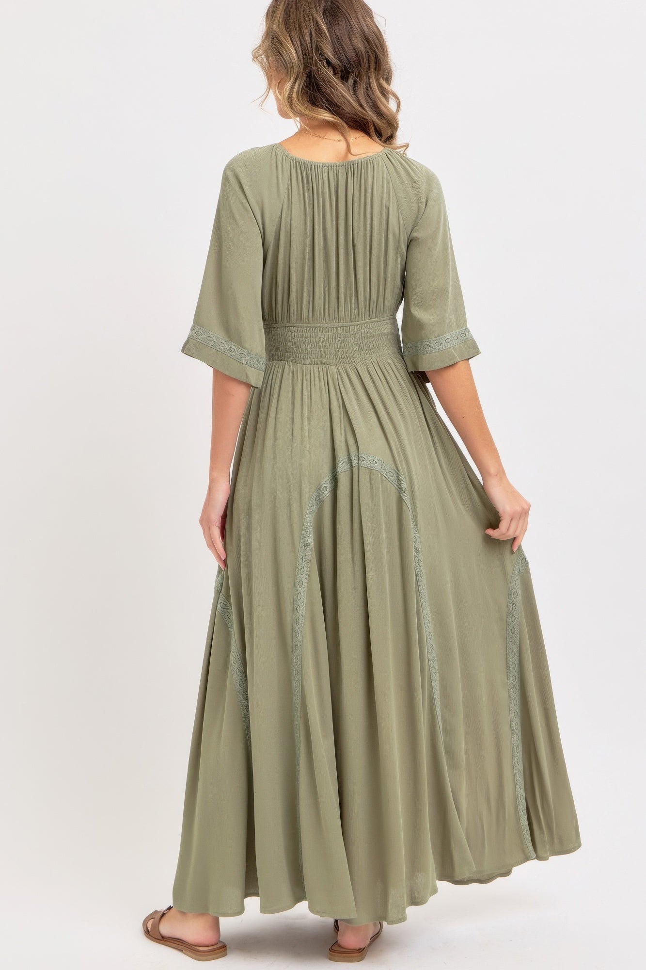 Dusty sage maxi dress, back view with smocked waist and embroidered lace hem