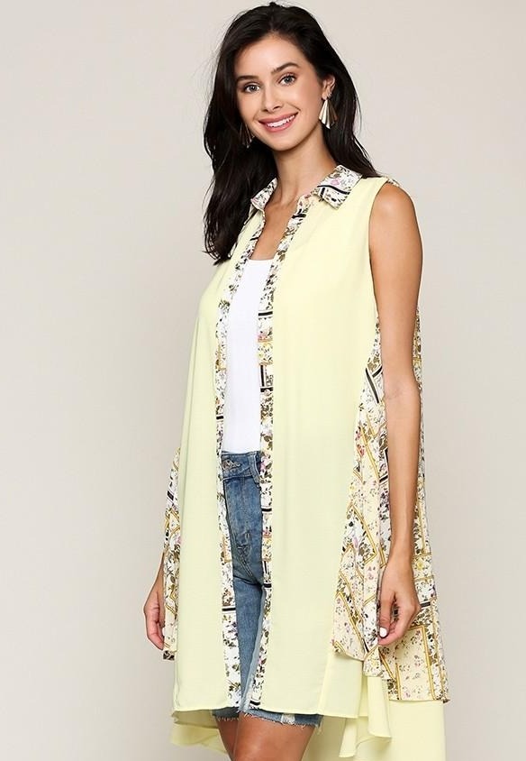 Yellow sleeveless collared printed dress with patterned trim and flowy A-line skirt