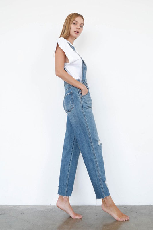 Denim Lab USA medium-wash ripped overall jumpsuit, side view of high waist bib.