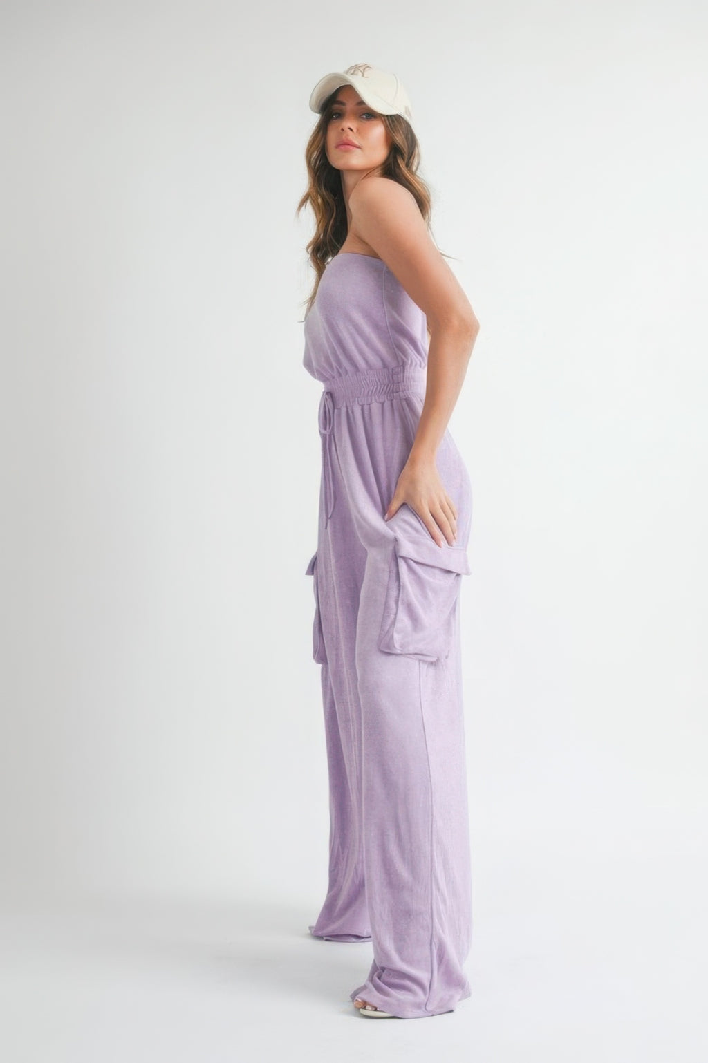 Lavender tube top jumpsuit with smocked waist and side cargo pocket details, long wide legs