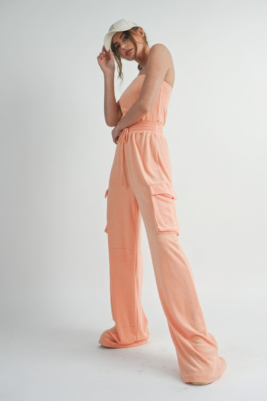 Peach tube top jumpsuit with drawstring waist and cargo pocket panels, wide legs