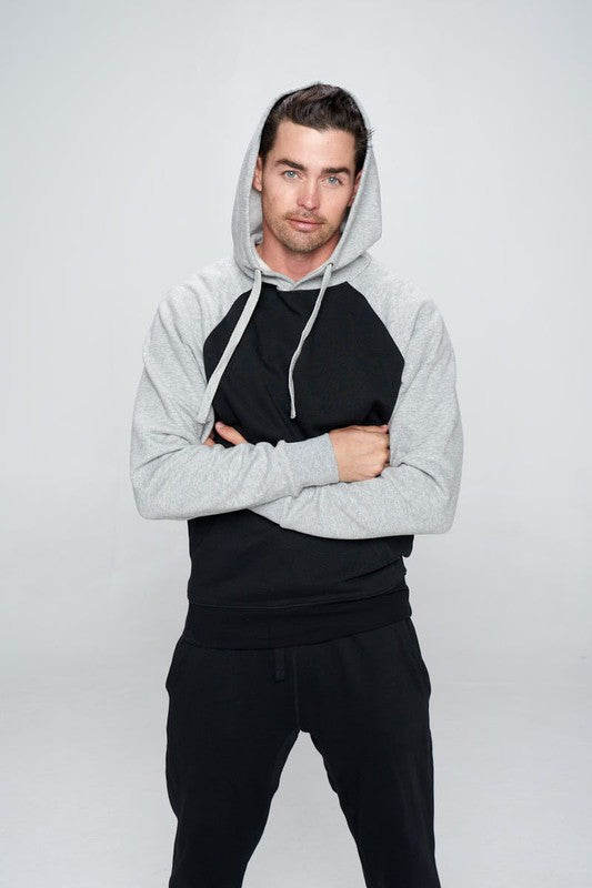 Black denim jacket with gray fleece hoodie, raglan sleeves and drawstring hood ties