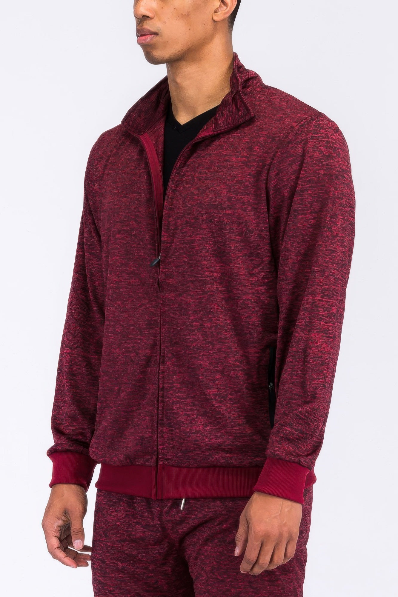Burgundy marbled track jacket from the side view, half-zip and front pocket seams