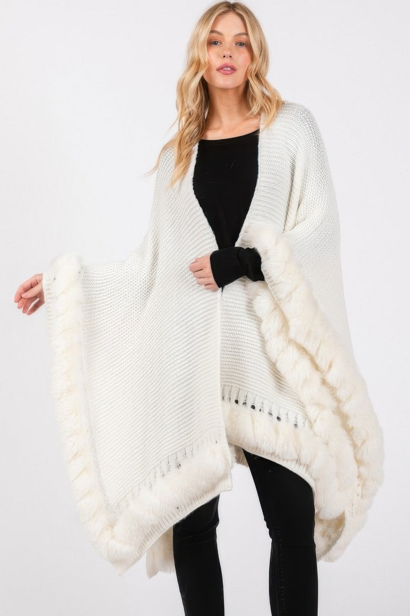 Ivory faux fur trim cape with fringed hem and draped sleeves
