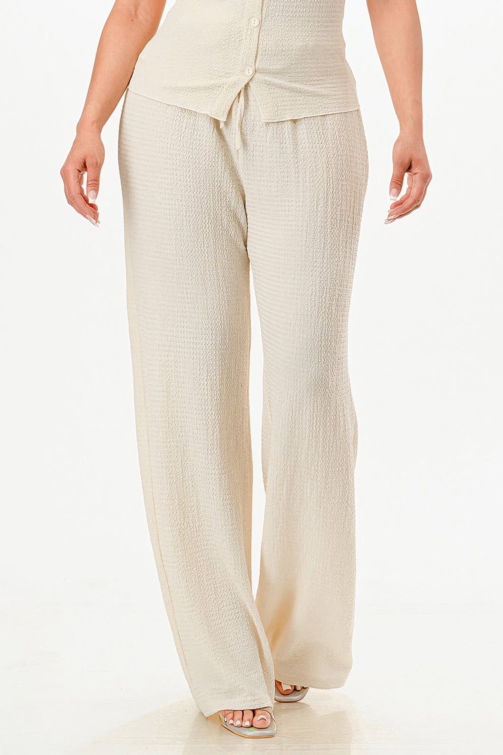Beige textured wide-leg pants with relaxed fit and side seam detailing