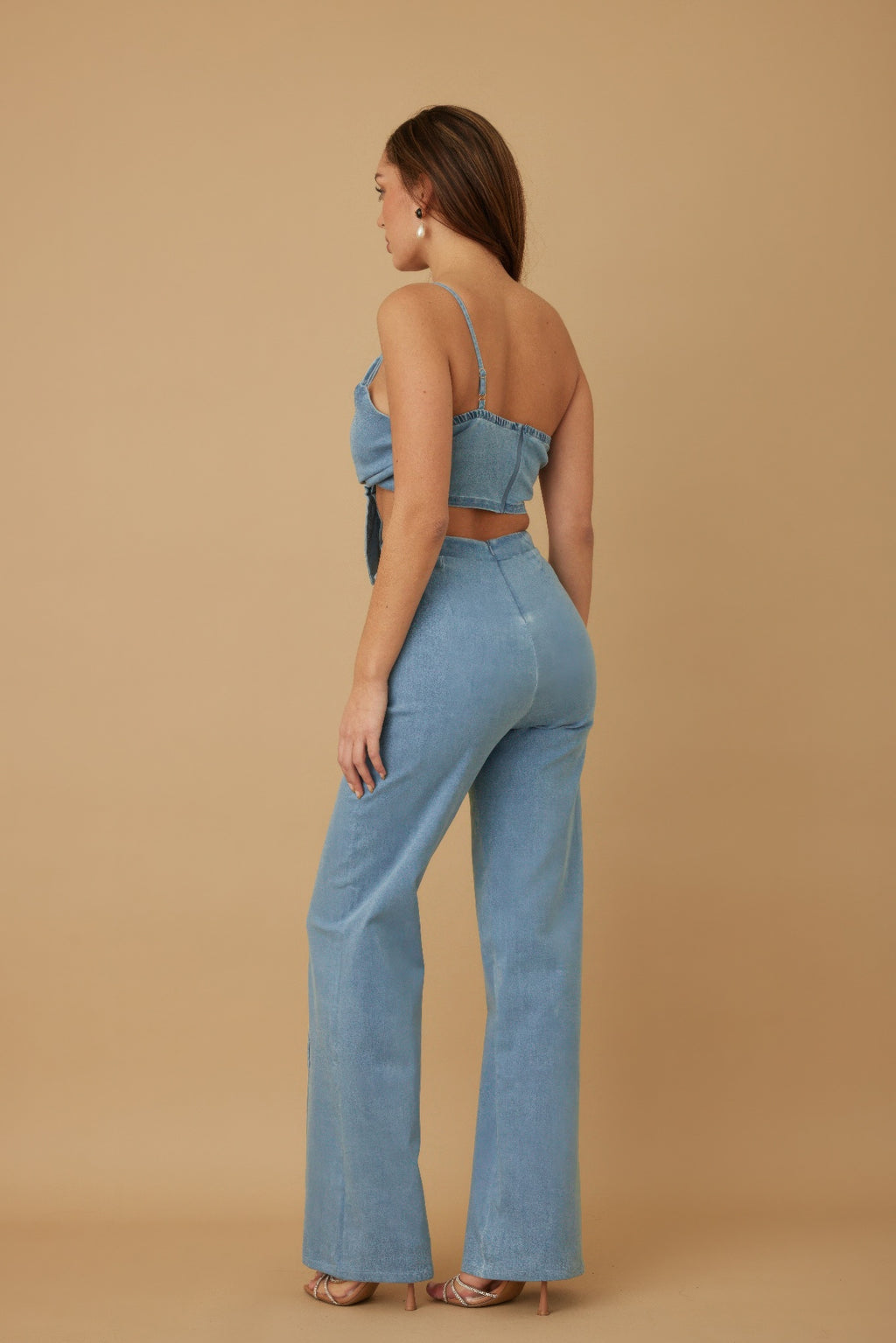 Side view of light denim blue wrap flower crop top and wide-leg pants